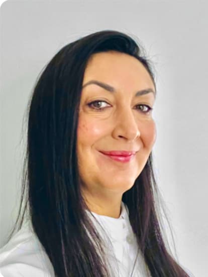 Smiling woman with long dark hair and a white shirt