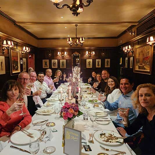 Dentists sat at a long table during a Dine with Denplan event