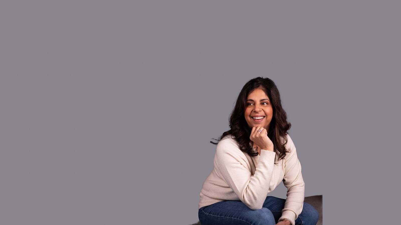 Dentist Nina smiling sitting on a chair