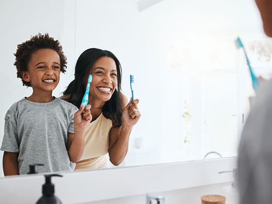Mother and son checking teeth in mirror