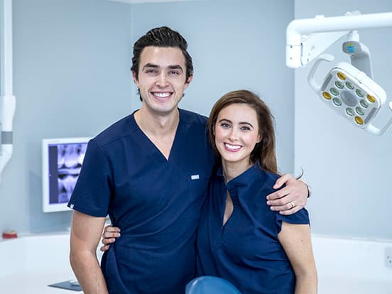 Dr Simon and Meghan Chard stood with arms around each other