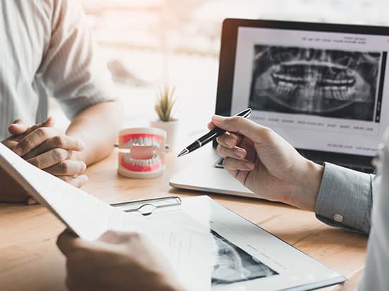 Dentist doing paperwork holding pen