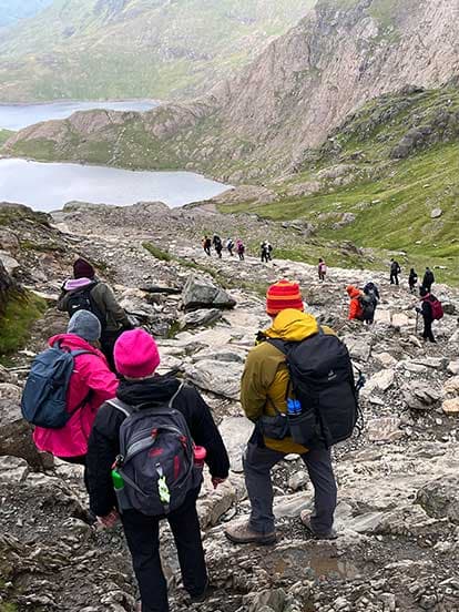 Dentists hiking down a rocky hillside during Snowdon Sunrise Hike