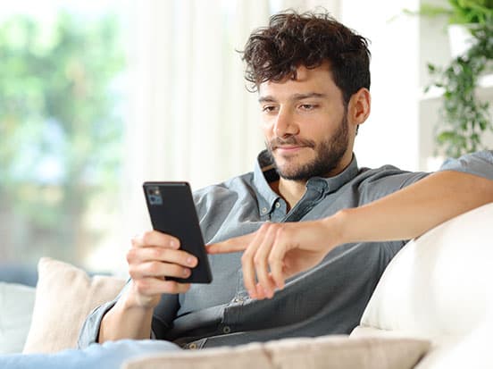 Man making a dental claim online using phone
